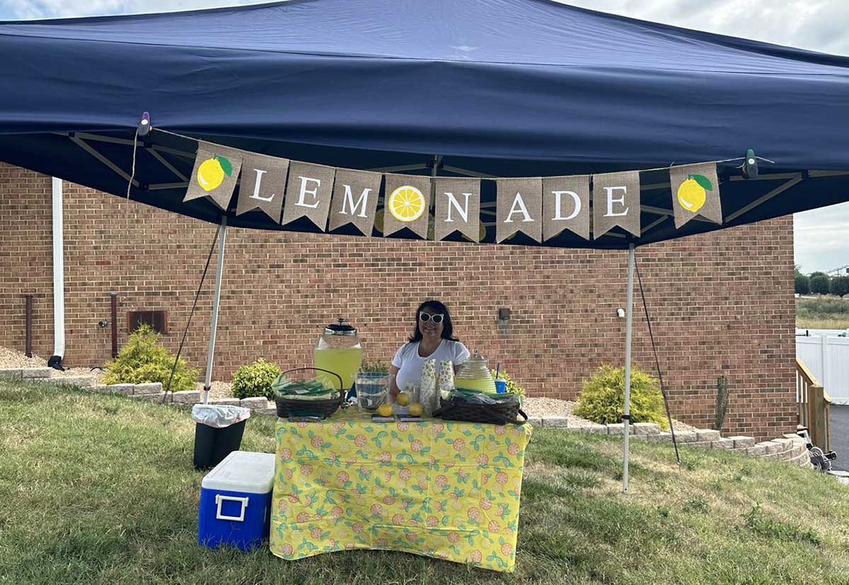 team hosting a lemonade stand for pets and pet owners
