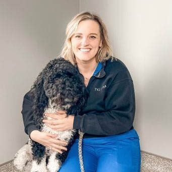Anissa with her black and white dog