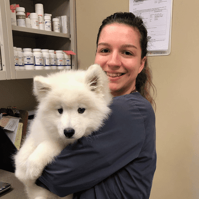 Chelsea holding a fluffy white puppy