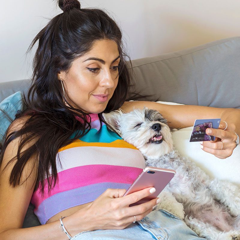 Credit Card woman with her dog paying for veterinary bills on her laptop